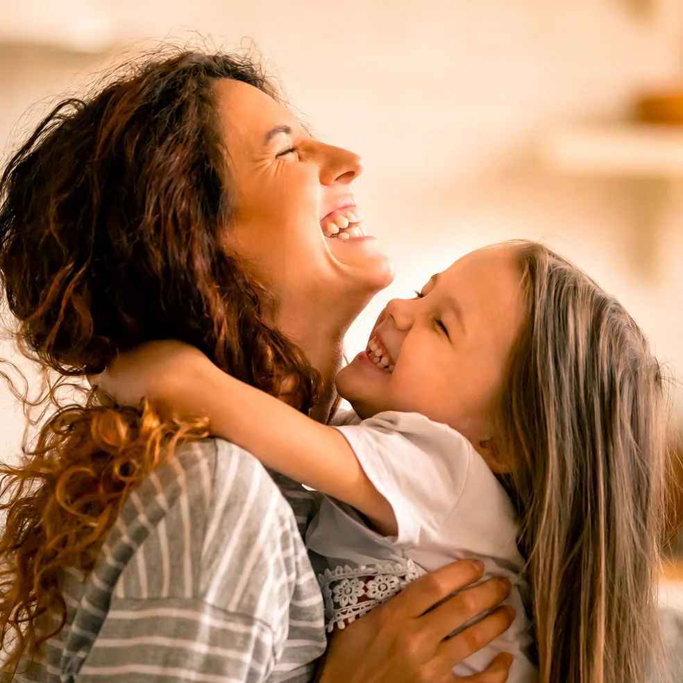Mother and child smiling together